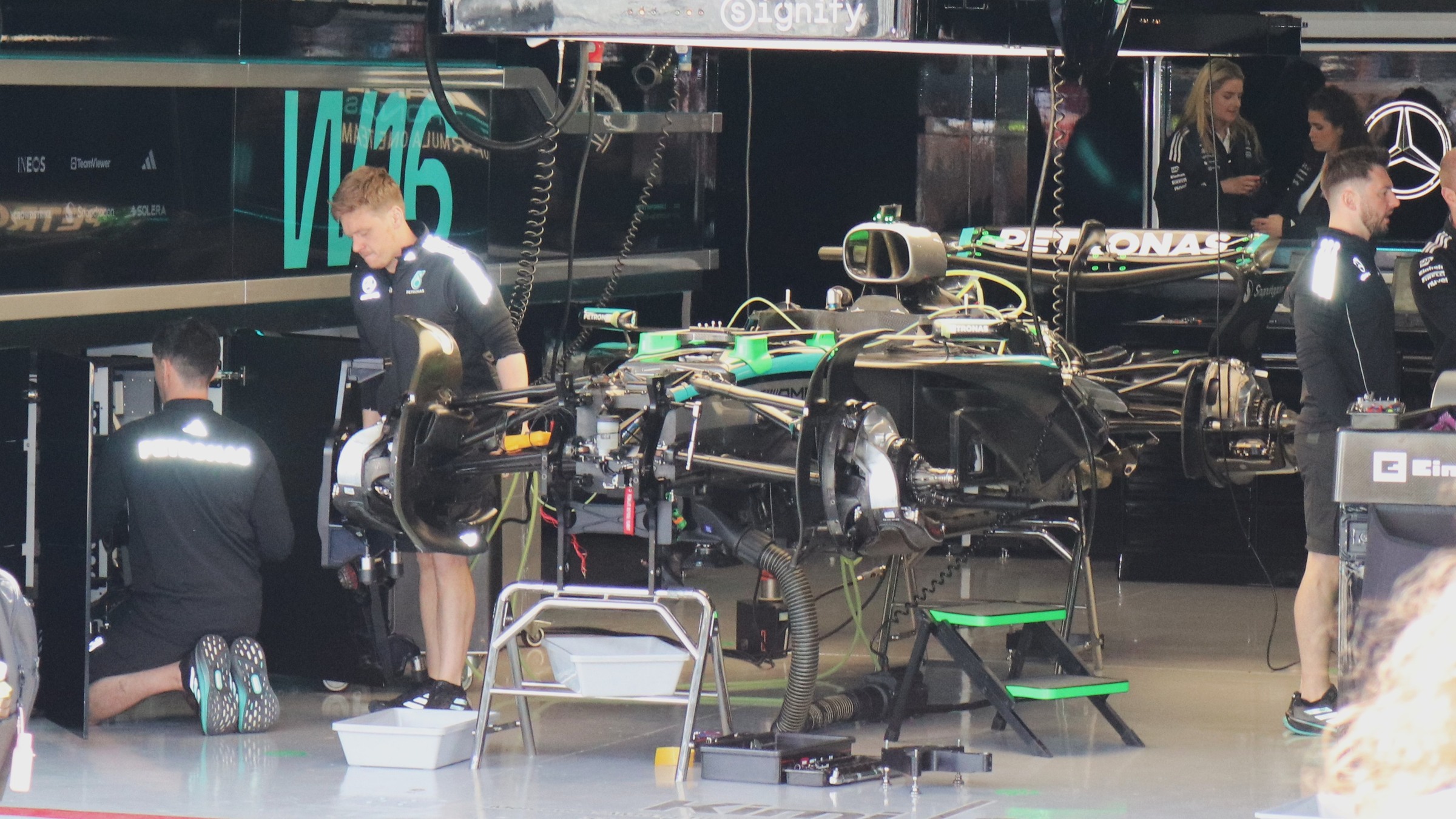Mercedes mechanics assemble the W16 Formula 1 car in the Suzuka pit garage during the 2025 Japanese Grand Prix